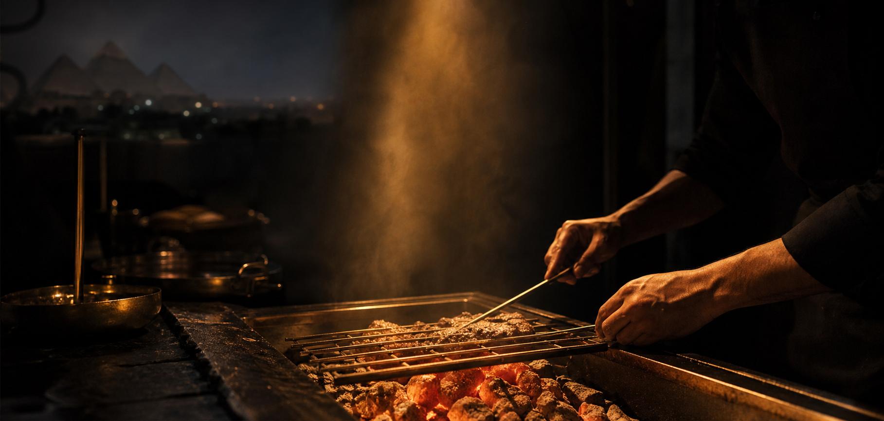 A chef tending glowing charcoal embers in Nocturnal’s open-fire kitchen